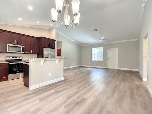 509 Mulberry St, Fruitland Park, FL 34731 - kitchen featuring lofted ceiling, a breakfast bar, ornamental molding, and appliances with stainless steel finishes