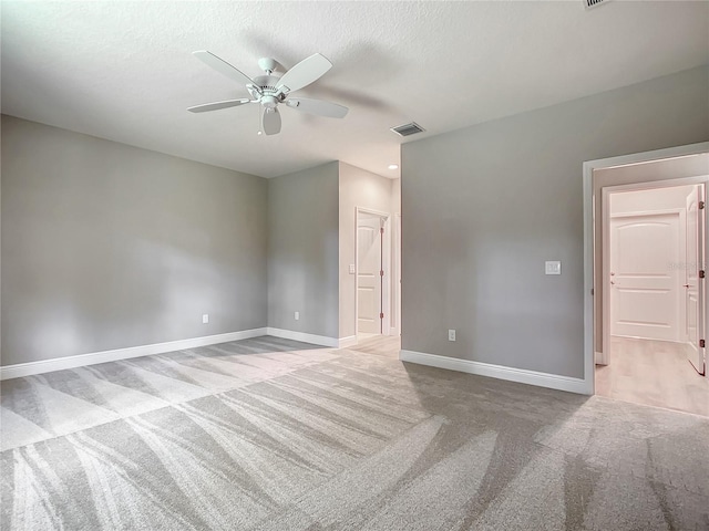 509 Mulberry St, Fruitland Park, FL 34731 - carpeted empty room featuring a textured ceiling, baseboards, ceiling fan, and visible vents