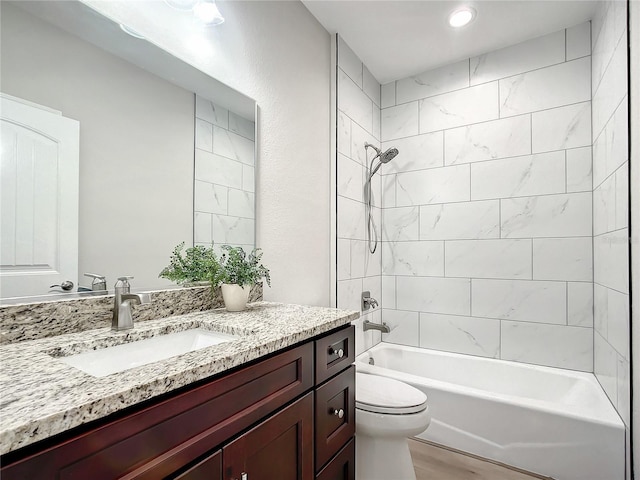509 Mulberry St, Fruitland Park, FL 34731 - bathroom with toilet, wood finished floors, vanity, and shower / washtub combination