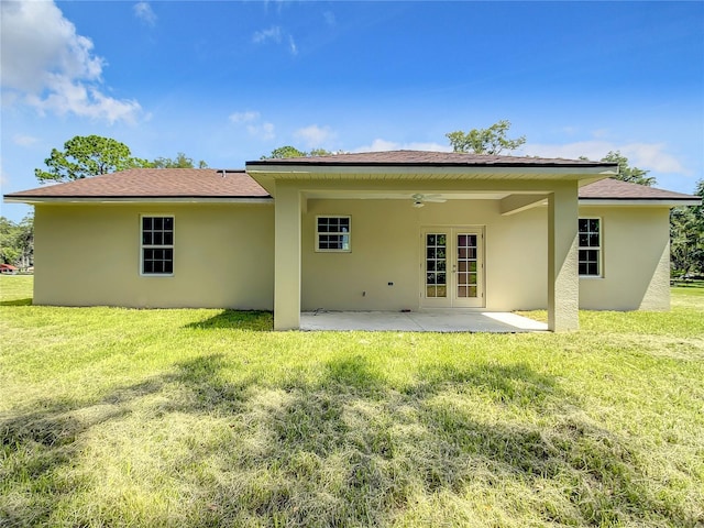 509 Mulberry St, Fruitland Park, FL 34731 - back of property with a lawn, stucco siding, a patio area, and french doors