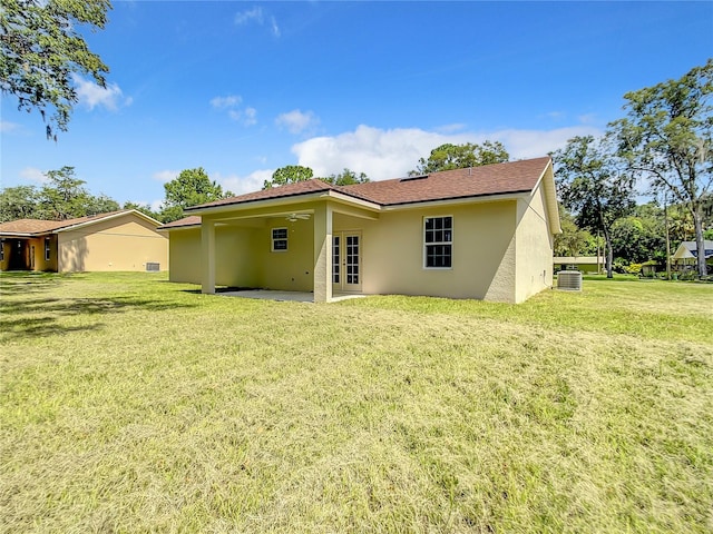509 Mulberry St, Fruitland Park, FL 34731 - rear view of property with cooling unit, stucco siding, a lawn, ceiling fan, and a patio area