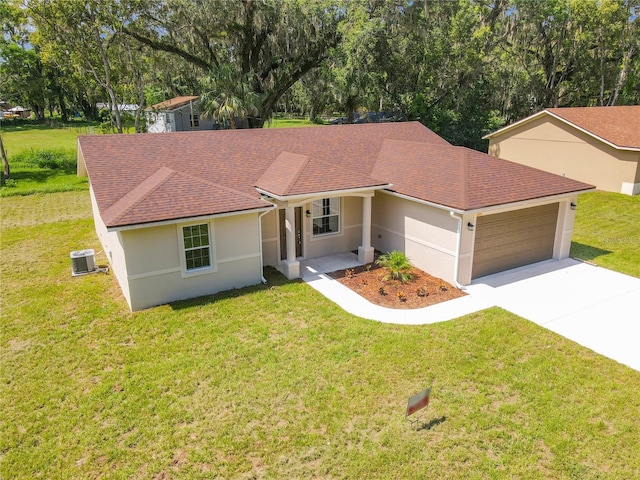 509 Mulberry St, Fruitland Park, FL 34731 - view of front of house featuring stucco siding, a garage, concrete driveway, and a front yard