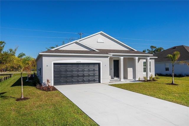 25372 Alicante Dr, Punta Gorda, FL 33955 - view of front of home featuring an attached garage, stucco siding, a front lawn, driveway, and roof with shingles