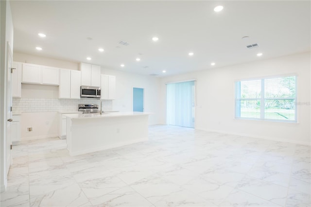 25372 Alicante Dr, Punta Gorda, FL 33955 - kitchen with visible vents, recessed lighting, stainless steel appliances, open floor plan, and a center island with sink