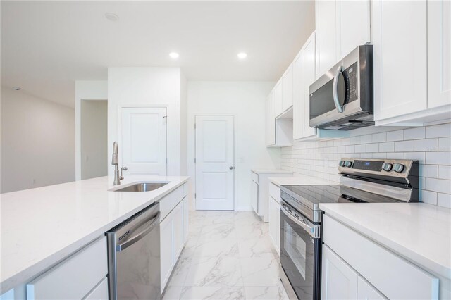 25372 Alicante Dr, Punta Gorda, FL 33955 - kitchen featuring light countertops, white cabinetry, appliances with stainless steel finishes, marble finish floor, and a sink
