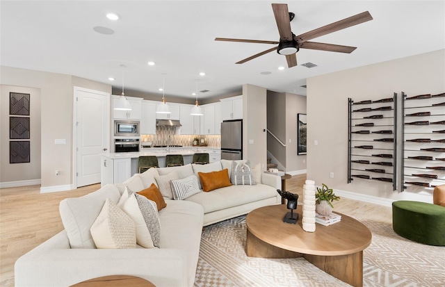 15446 Orchard Garden St, Winter Garden, FL 34787 - living room with light wood-style floors, visible vents, recessed lighting, and a ceiling fan
