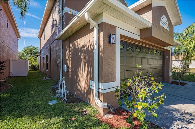 31028 Baclan Dr, Wesley Chapel, FL 33545 - view of property exterior featuring stucco siding, concrete driveway, a garage, and a lawn