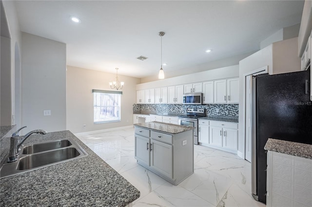 31028 Baclan Dr, Wesley Chapel, FL 33545 - kitchen with decorative backsplash, visible vents, marble finish floor, appliances with stainless steel finishes, and a sink