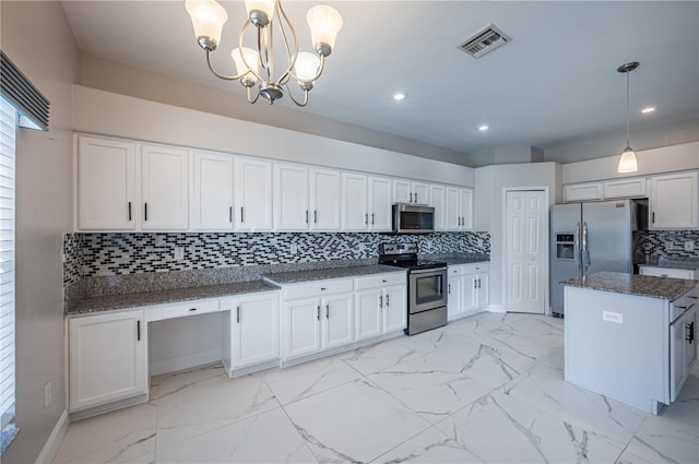 31028 Baclan Dr, Wesley Chapel, FL 33545 - kitchen featuring white cabinets, visible vents, marble finish floor, appliances with stainless steel finishes, and an inviting chandelier