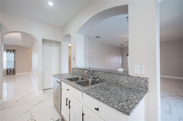 31028 Baclan Dr, Wesley Chapel, FL 33545 - kitchen with marble finish floor, stainless steel dishwasher, stone counters, and a sink