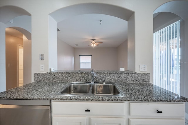 31028 Baclan Dr, Wesley Chapel, FL 33545 - kitchen featuring white cabinets, ceiling fan, dark stone counters, a sink, and stainless steel dishwasher