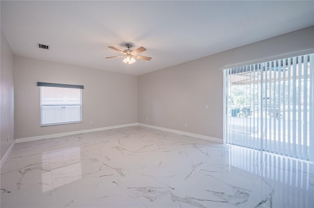 31028 Baclan Dr, Wesley Chapel, FL 33545 - empty room with marble finish floor, baseboards, ceiling fan, and visible vents