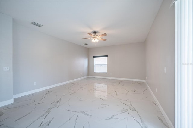 31028 Baclan Dr, Wesley Chapel, FL 33545 - spare room featuring marble finish floor, baseboards, ceiling fan, and visible vents