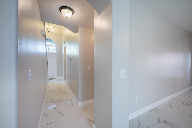 31028 Baclan Dr, Wesley Chapel, FL 33545 - hall with an inviting chandelier, marble finish floor, arched walkways, and baseboards