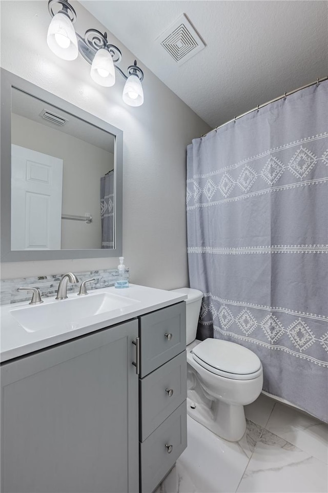 31028 Baclan Dr, Wesley Chapel, FL 33545 - full bathroom featuring marble finish floor, visible vents, toilet, and vanity