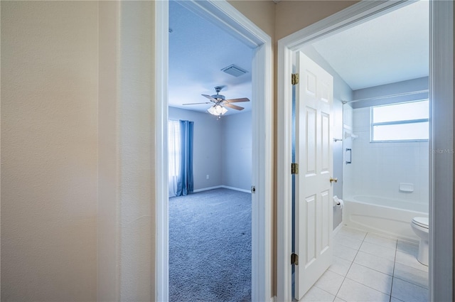 31028 Baclan Dr, Wesley Chapel, FL 33545 - hallway with light tile patterned floors, baseboards, light colored carpet, and visible vents