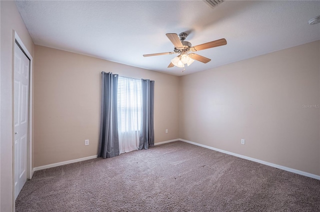31028 Baclan Dr, Wesley Chapel, FL 33545 - unfurnished bedroom featuring baseboards, visible vents, ceiling fan, and carpet floors