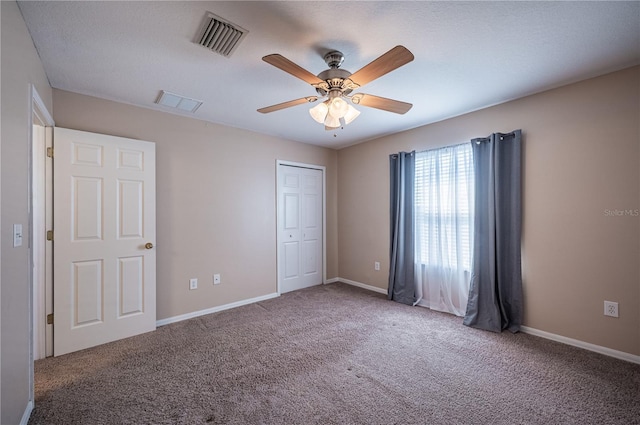 31028 Baclan Dr, Wesley Chapel, FL 33545 - unfurnished bedroom with baseboards, visible vents, a closet, and carpet floors