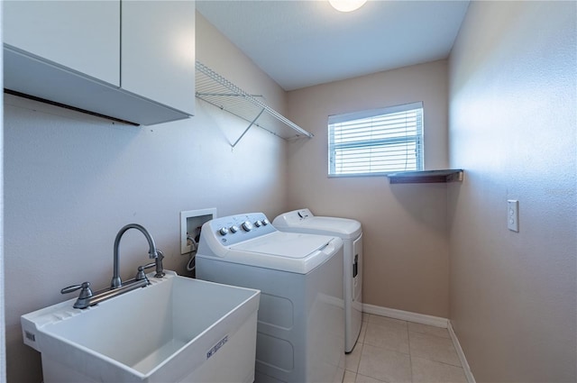 31028 Baclan Dr, Wesley Chapel, FL 33545 - laundry room with independent washer and dryer, baseboards, a sink, light tile patterned flooring, and cabinet space