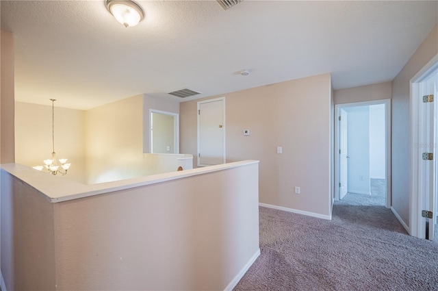 31028 Baclan Dr, Wesley Chapel, FL 33545 - hall featuring an upstairs landing, an inviting chandelier, carpet flooring, baseboards, and visible vents