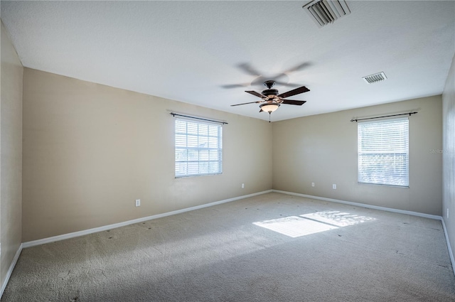 31028 Baclan Dr, Wesley Chapel, FL 33545 - empty room with baseboards, ceiling fan, visible vents, and light carpet