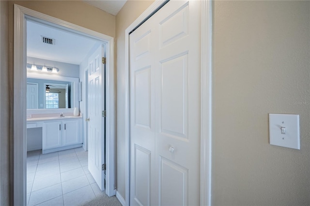 31028 Baclan Dr, Wesley Chapel, FL 33545 - hall with visible vents, a sink, and light tile patterned floors