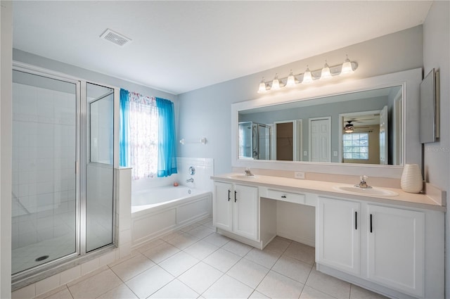 31028 Baclan Dr, Wesley Chapel, FL 33545 - bathroom with tile patterned floors, a sink, a stall shower, a garden tub, and visible vents