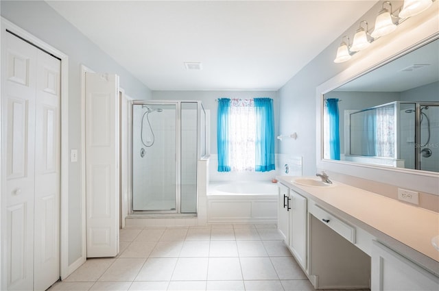 31028 Baclan Dr, Wesley Chapel, FL 33545 - bathroom with tile patterned floors, a sink, a garden tub, a shower stall, and double vanity