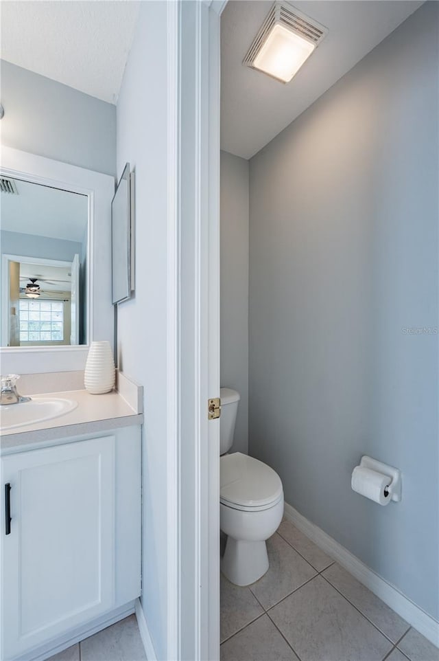 31028 Baclan Dr, Wesley Chapel, FL 33545 - bathroom with visible vents, baseboards, toilet, tile patterned floors, and vanity
