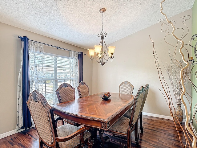 556 Hummingbird Ct, Kissimmee, FL 34759 - dining space with baseboards, dark wood-style flooring, a textured ceiling, and an inviting chandelier