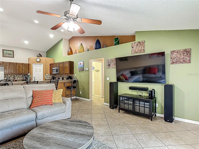 556 Hummingbird Ct, Kissimmee, FL 34759 - living room with light tile patterned flooring, baseboards, vaulted ceiling, and ceiling fan