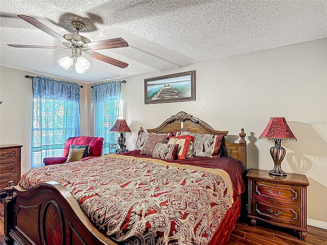 556 Hummingbird Ct, Kissimmee, FL 34759 - bedroom with a textured ceiling, wood finished floors, and a ceiling fan