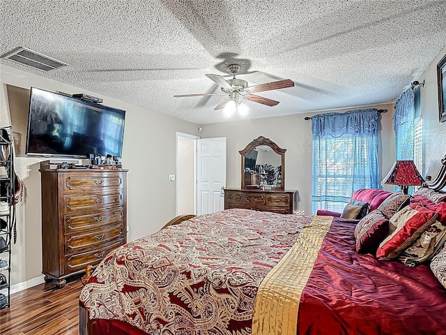 556 Hummingbird Ct, Kissimmee, FL 34759 - bedroom with a ceiling fan, wood finished floors, a textured ceiling, and visible vents