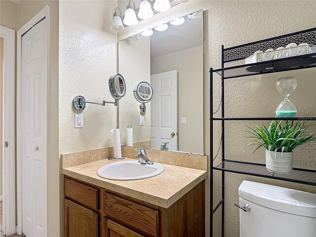 556 Hummingbird Ct, Kissimmee, FL 34759 - bathroom with a textured wall, toilet, and vanity