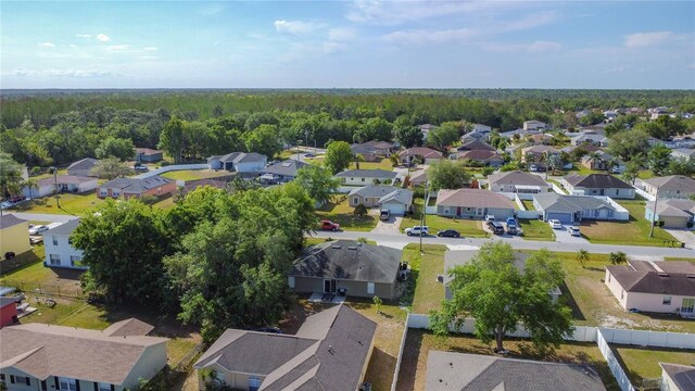 556 Hummingbird Ct, Kissimmee, FL 34759 - birds eye view of property featuring a residential view and a wooded view