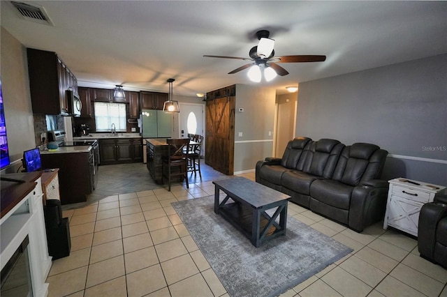 1491 Lavender St, Deltona, FL 32725 - living room with light tile patterned floors, ceiling fan, and visible vents