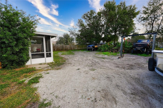 1491 Lavender St, Deltona, FL 32725 - exterior space featuring a sunroom, fence, and a carport