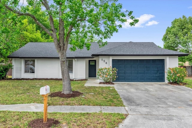view of front of home with a garage, stucco siding, a front lawn, a shingled roof, and driveway
