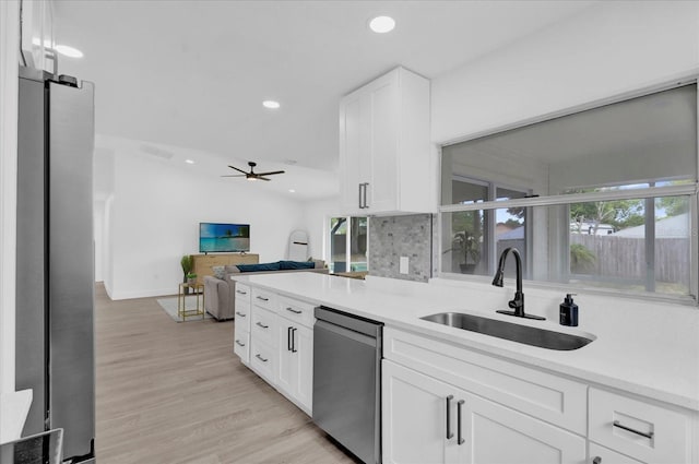 kitchen with ceiling fan, stainless steel dishwasher, white cabinetry, recessed lighting, and a sink