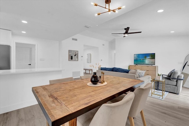 dining area with visible vents, recessed lighting, light wood-style floors, and ceiling fan with notable chandelier