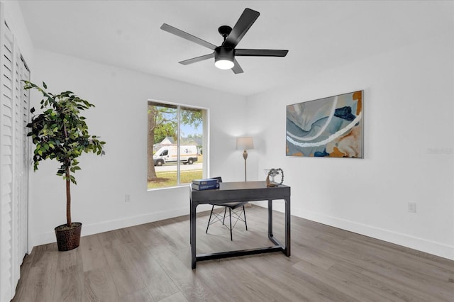 office space with baseboards, a ceiling fan, and wood finished floors