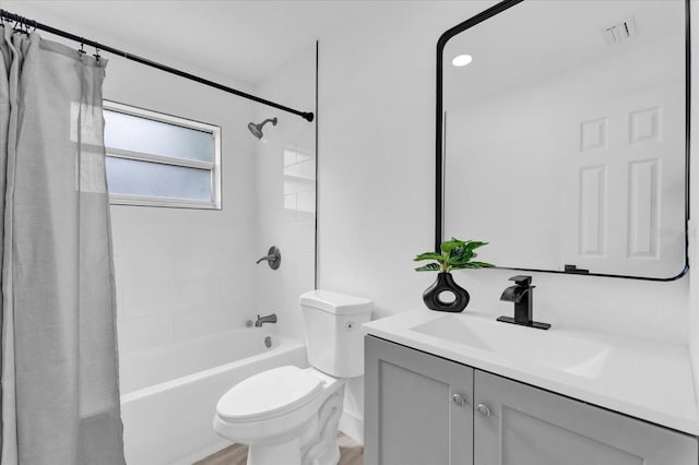 bathroom featuring shower / bathtub combination with curtain, vanity, visible vents, toilet, and wood finished floors