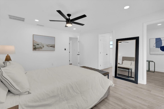 bedroom featuring light wood-type flooring, baseboards, visible vents, and recessed lighting