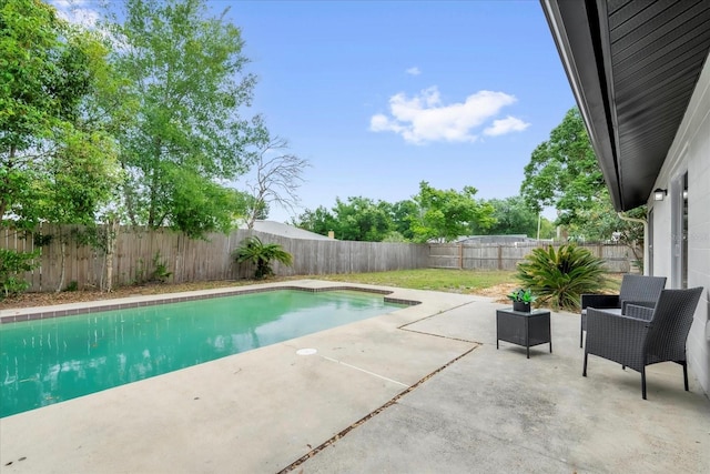 view of pool featuring a patio area and a fenced backyard