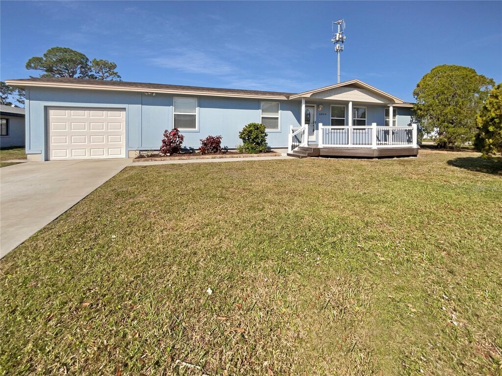 6804 11th St W, Bradenton, FL 34207 - single story home featuring a garage, a front lawn, concrete driveway, and a porch