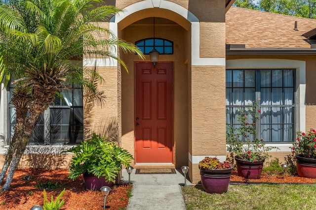 2721 Village Pine Ter, Orlando, FL 32833 - entrance to property featuring stucco siding and roof with shingles