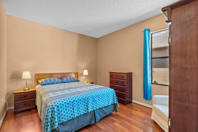 2721 Village Pine Ter, Orlando, FL 32833 - bedroom with wood finished floors and a textured ceiling