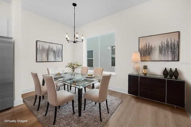 927 City Walk Ln, Oviedo, FL 32765 - dining room featuring baseboards, a notable chandelier, and wood finished floors