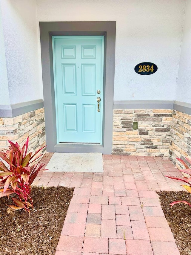 2834 Narcoossee Commons Way, Saint Cloud, FL 34771 - entrance to property with stone siding and stucco siding