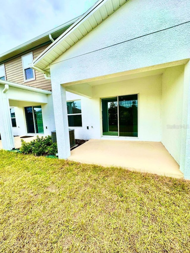 2834 Narcoossee Commons Way, Saint Cloud, FL 34771 - back of house featuring central AC unit, a patio, a yard, and stucco siding